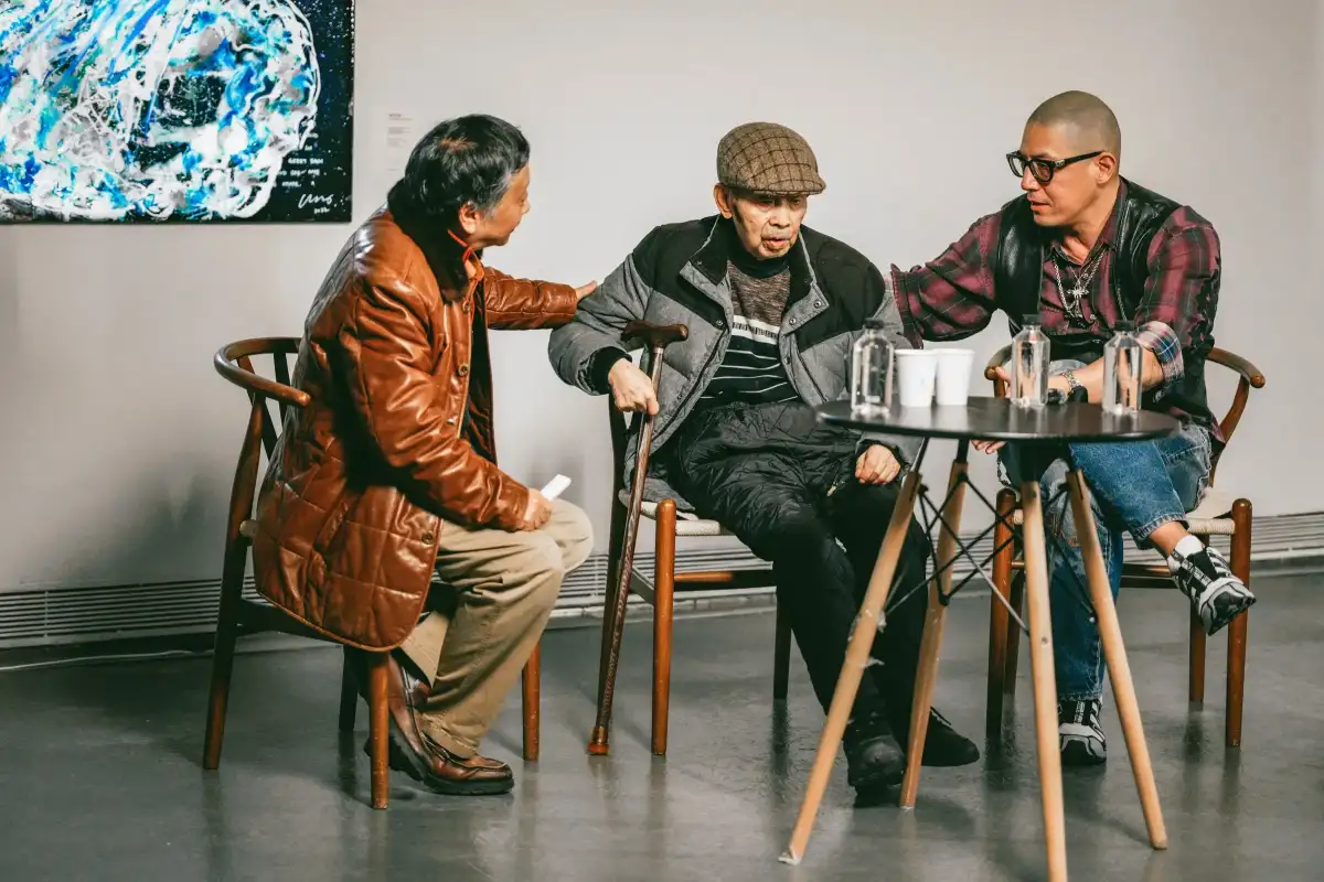 Three people in conversation during a public programme.
