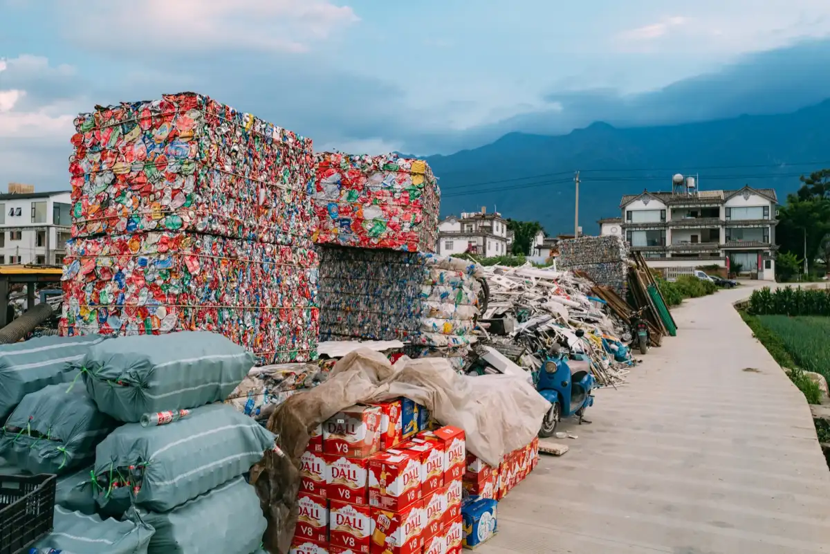 Compressed recycling blocks against distant mountains.
