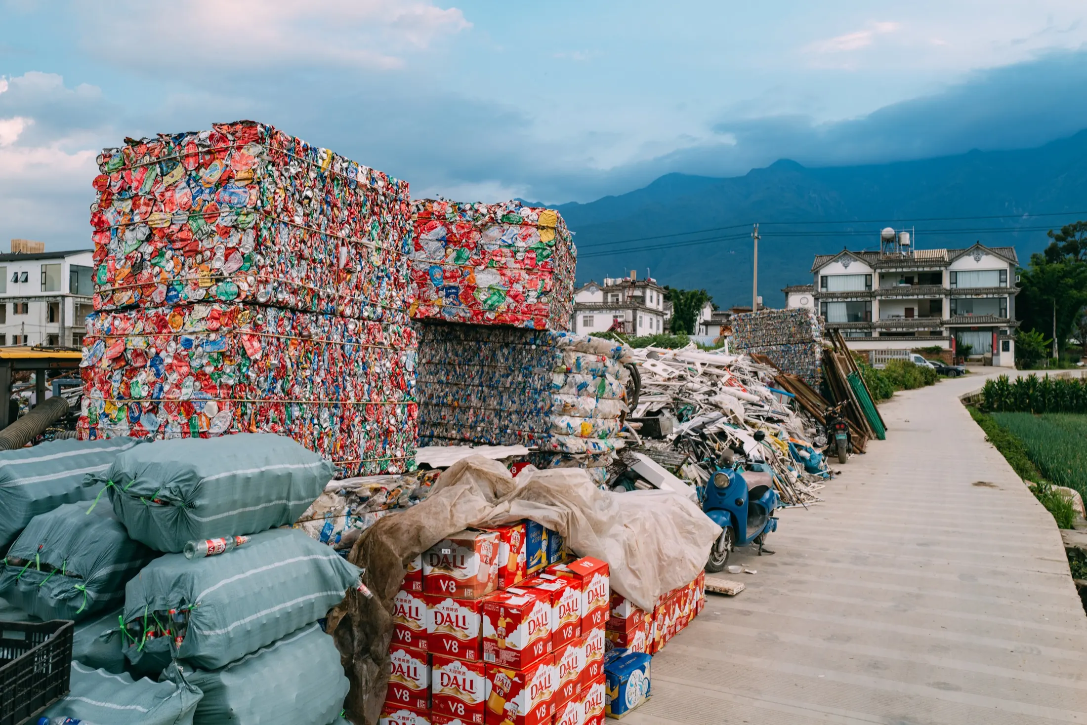 Compressed recycling blocks against distant mountains.